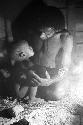 Samuel Putnam negatives, New Guinea; a man and child inside of a hunu