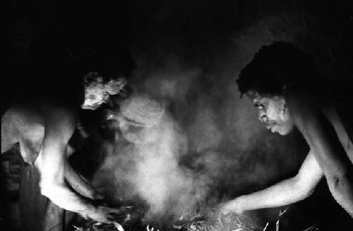 Samuel Putnam negatives, New Guinea; 2 women working on hakse inside of lise