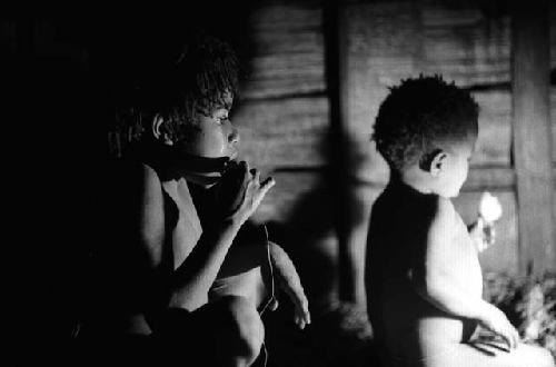 Samuel Putnam negatives, New Guinea; 2 children eating in hunu at night