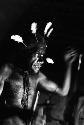 Samuel Putnam negatives, New Guinea; Wali in his honai in Lokoparek; putting feathers into his hair net