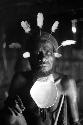 Samuel Putnam negatives, New Guinea; Wali adjusting feathers in his head