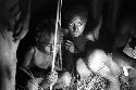 Children near a Coleman lamp who are on the Liberek during the celebration at night for the killing of the Asukpalek man