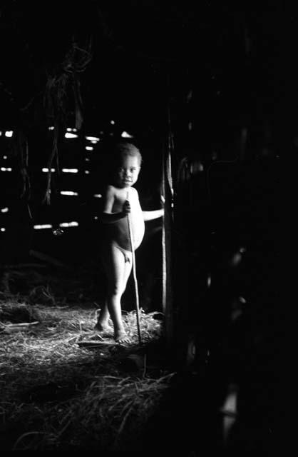 Samuel Putnam negatives, New Guinea; Little boy stands in the doorway