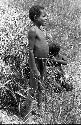 Karl Heider negatives, New Guinea; Uwar standing beside toy hanoi