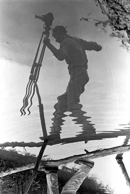 Karl Heider negatives, New Guinea; A shadow of Robert Gardner carrying camera