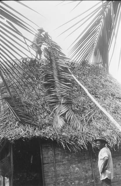 Pulling woven saddle board up on roof