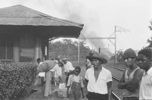 Group of men, boy at train station