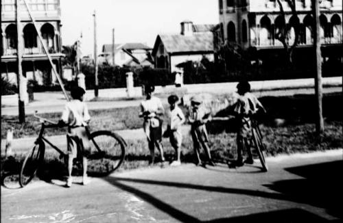 Boys and bicycles in street