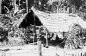 Small 4-pillar house with medicine man's consultation room to right