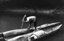 Boatman tying one of the expedition's korials to semi-submerged log for the night.