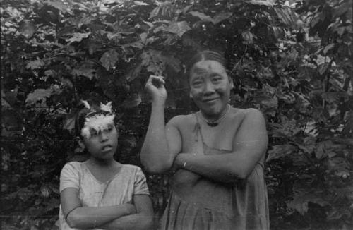 Woman and girl in festive ornament -- note powis down on girl's forehead.