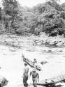 Scenes showing the process of taking korials over the great falls at Towakaima.