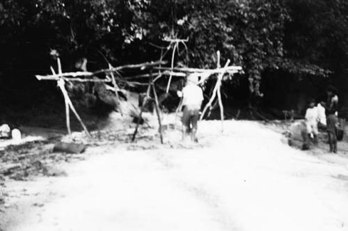 Views showing method of constructing a temporary shelter frame.