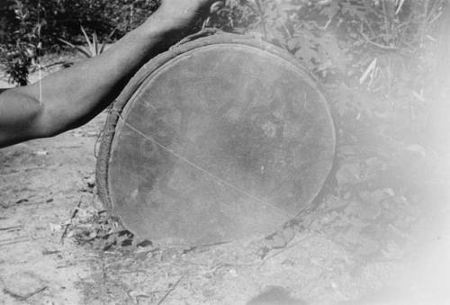 Drum -- note string across the head with "tooth pick" resonator.