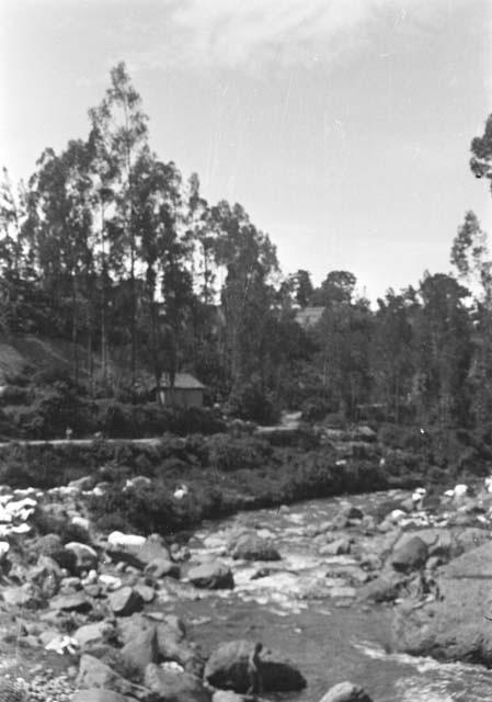 Woman washing clothes in Rio Ibarra