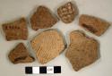 Coarse earthenware body sherds, some cord impressed, some impressed or punctate