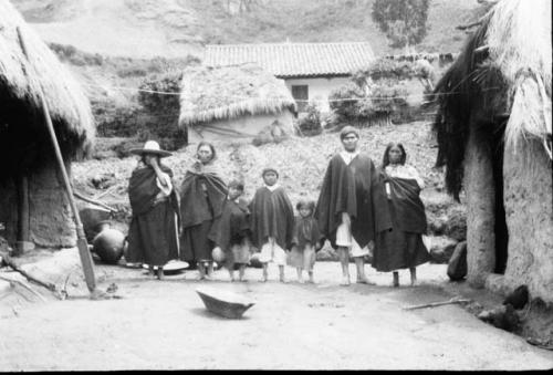 House group showing costumes, at left wooden spade, in foreground is a wooden mixing bowl.