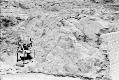 Further views of bridge and expedition materials being ferried across in cable car.