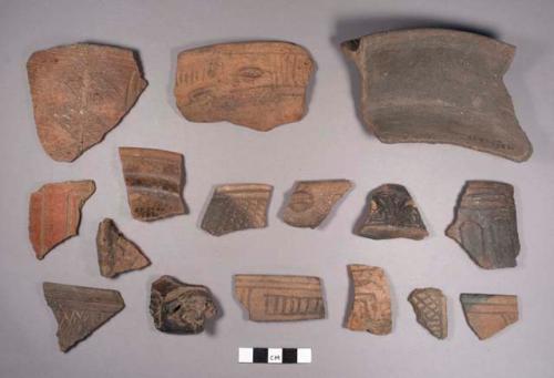 16 coarse incised black-brown ware sherds