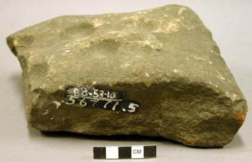 Ground stone with large pits