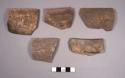 5 weathered fugitive black ware sherds from incurving bowls with flat rims