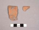 2 red ware sherds from outcurving rim bowls with horizontal grooving