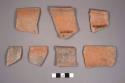 7 weathered fugitive black ware sherds from incurving bowls