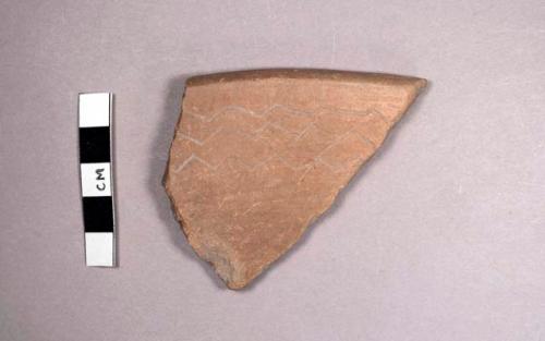 Tan incised rim potsherd