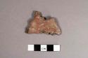 Red perforated potsherd
