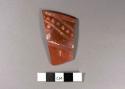 Orange on polished red potsherd