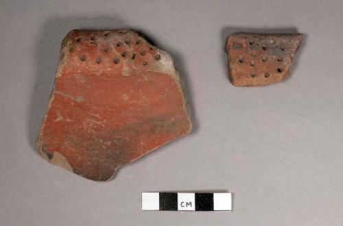 2 red rim potsherds with deep punctation