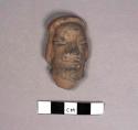Pottery figurine head - female