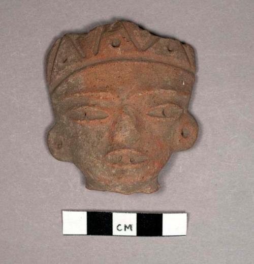 Pottery figurine head with incised headdress