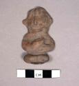 Seated pottery figurine