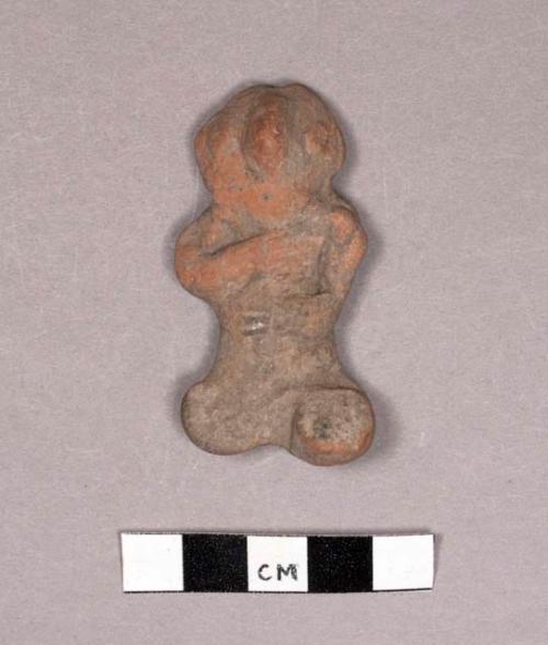 Crude pottery seated figurine