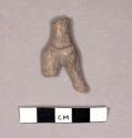 Legs and body of small white painted pottery figurine