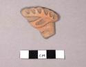 Fragment of flat pottery figurine head?