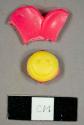 Plastic pink and yellow smileyface toy fragments