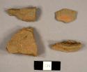 Red earthenware sherds, including one with fragments of lead glaze and one possible roofing tile