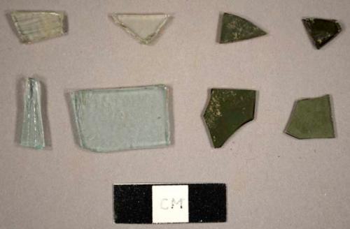 Assorted flat glass fragments, including colorless, aqua, and olive green fragments