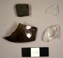 Miscellaneous curved glass fragments, including colorless and olive green fragments