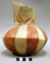 Ceramic vessel, long flared neck, red painted design, depression in base