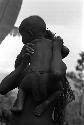 Girl holds Wamasue, who wears bark cloth 'diaper' (tani)