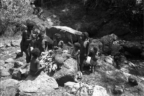 Ilueaima ('Kurelu Salt Well'). women and girls on rocks.