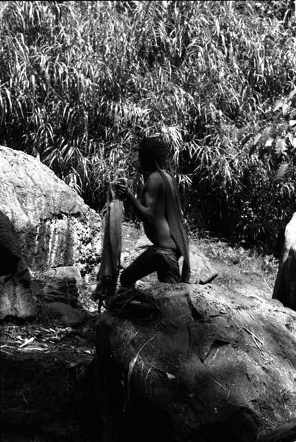 Ilueaima ('Kurelu Salt Well'). women knead banana stems in brine pool.