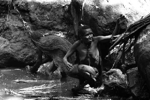 Ilueaima ('Kurelu Salt Well'). women knead banana stems in brine pool.