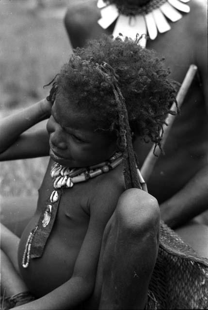 girl wearing yellow cane segment necklace.