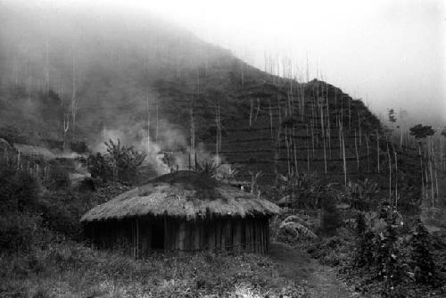 round house in village; terraced gardens in b.g.