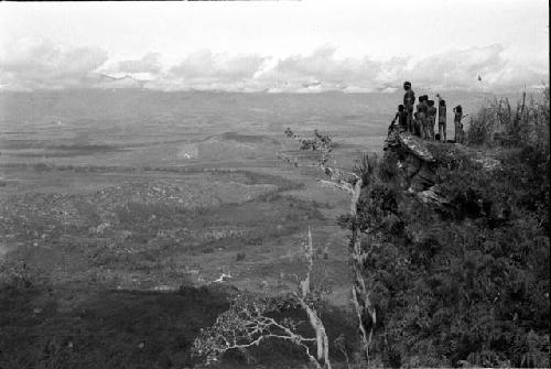 Kids on promontory above mountain wall, looking across GV