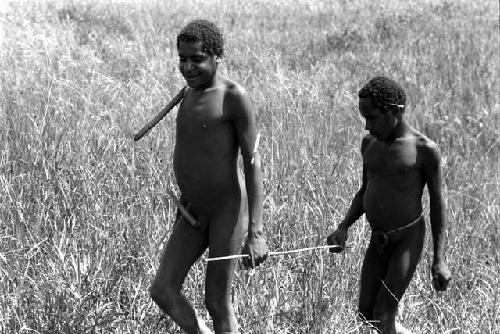 Dlegalok leads blind boy with stick.